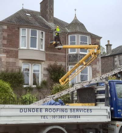A Dundee Roofing Services van beside a cherry picker at work on a Dundee sandstone villa