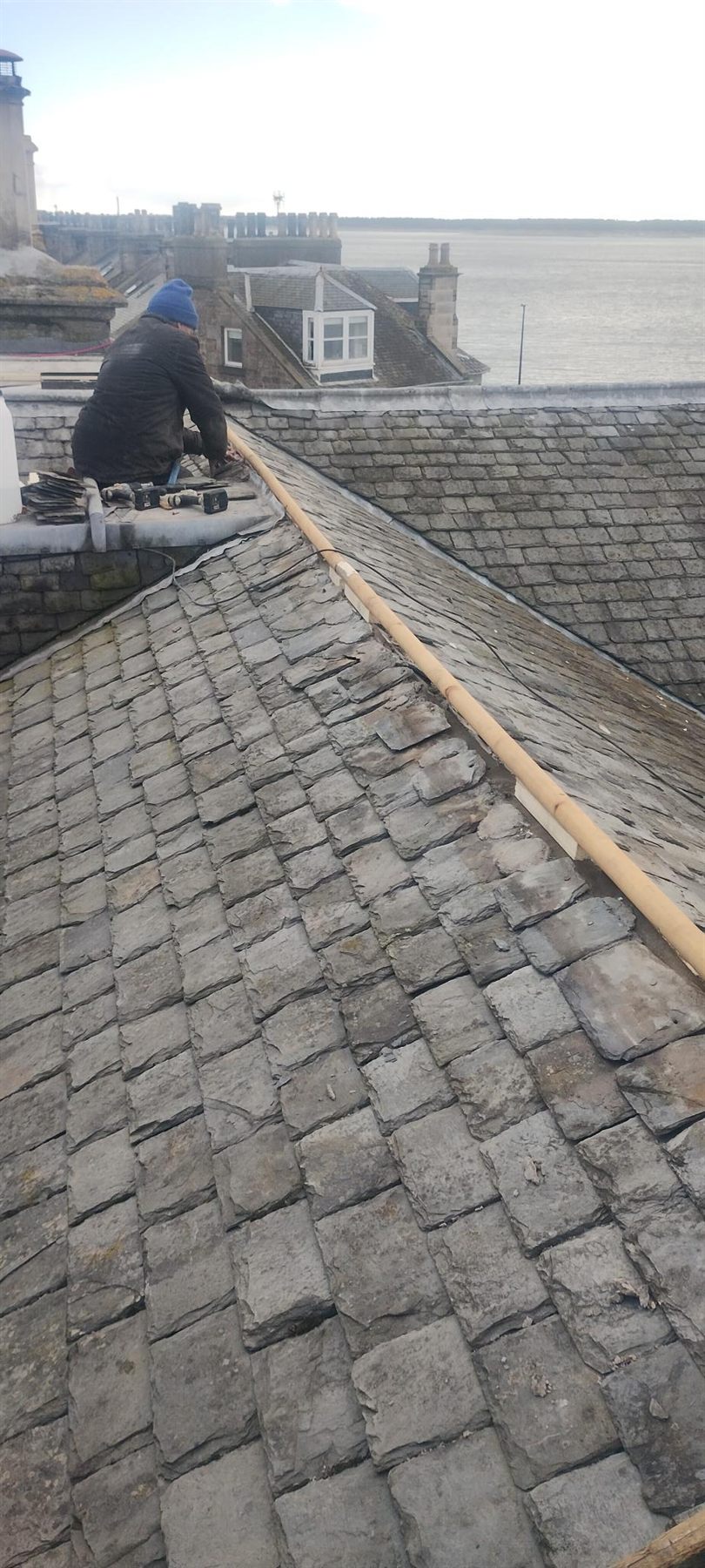 Slating around a dormer — Sound slates salvaged and re-laid, broken ones replaced, and the dormer cheeks made watertight again.